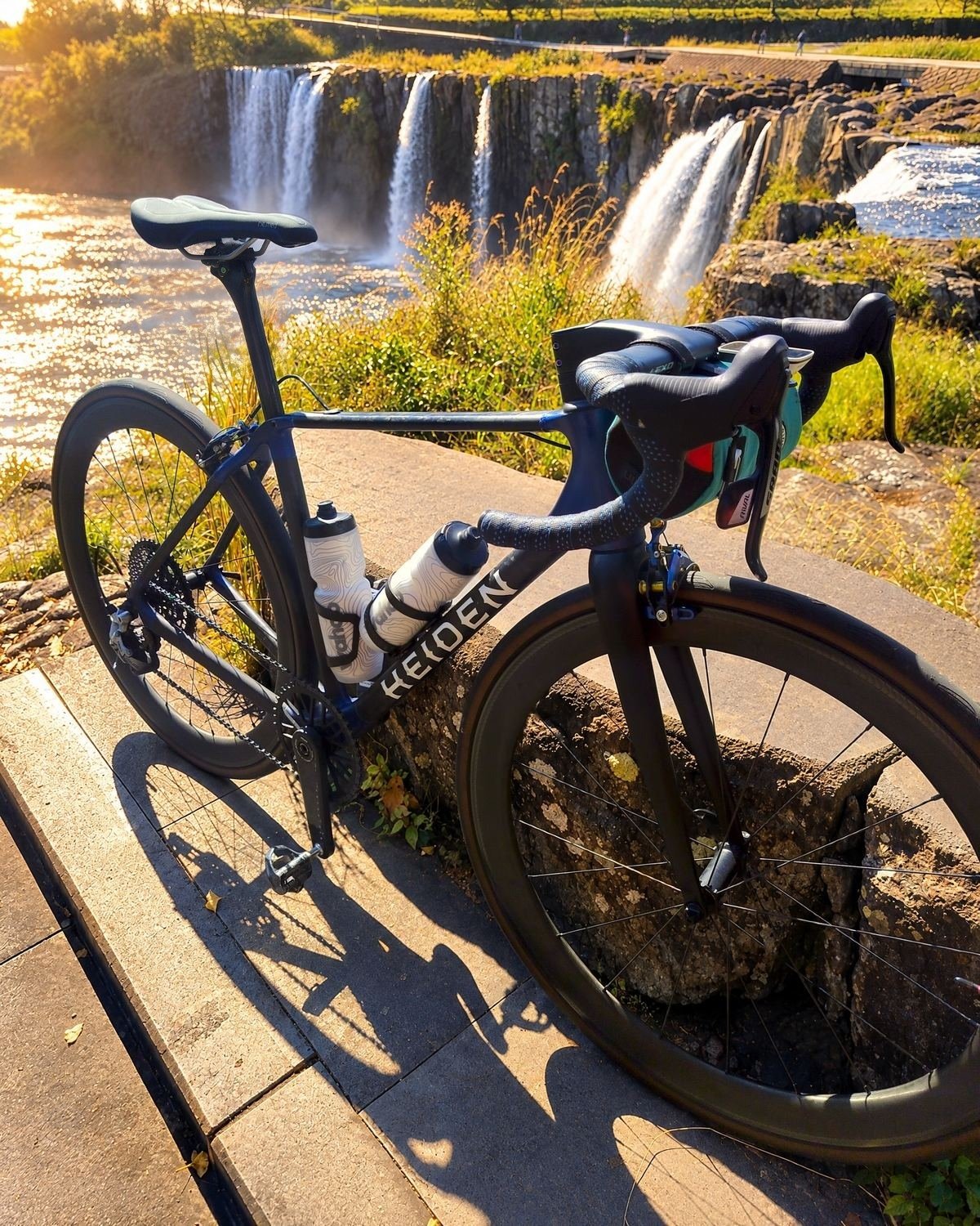 Heiden bike beside a wide waterfall
